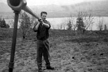 Phil Bartle changing irrigation sprinklers in an orchard 1959