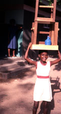 Kukuwa taking her desk and chair to school
